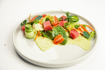 Tuna salad with signature dressing on a plate. Ingredients Iceberg lettuce, tuna, cherry tomatoes, spinach, carrots, cucumber, specialty sauce. For restaurant menu