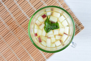 Colorful italian sodas with chopped fruits on white wooden background