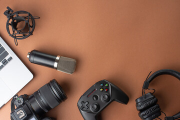 Microphone and headphones studio laptop and camera joystick or gamepad on the background, blogger, stream, gamer playing radio and podcasts. top view, flat lay © Anton