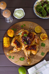 Spatchcocked chicken with sweet corn and yoghurt sauce. View from above, top view