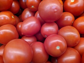 lot of tomatoes in the market closeup photo
