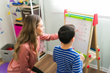 Caucasian tutor giving a math class to an elementary boy