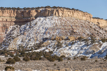 Closeup of beautiful rocky mountain covered in snow in rural New Mexico on clear blue day