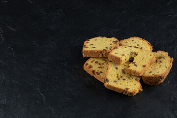 Pie slices with black sultana on a dark background