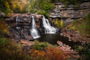 Fototapeta na wymiar Blackwater Falls in surrounded by Autumn colors within Blackwater Falls State Park, West Virginia.