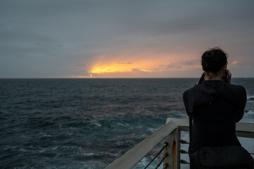 lady person from behind taking photo of sunrise