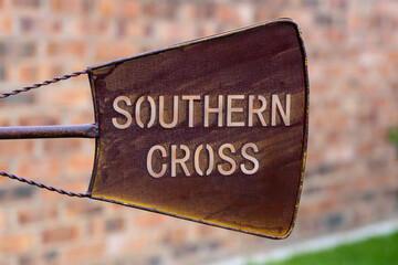 metal windmill in backyard with the word southern cross on it
