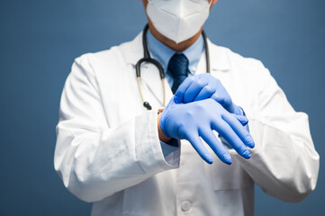 male doctor wears clean protective gloves before examination