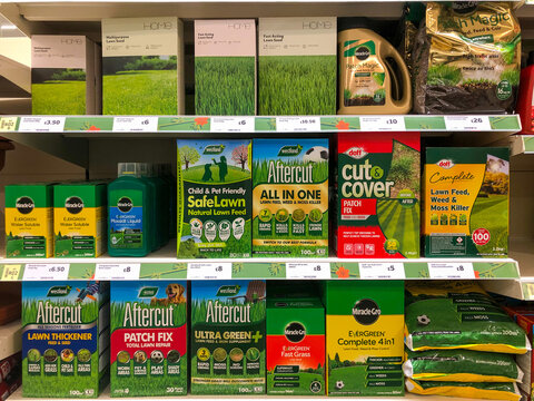 A Display Unit Full Of Grass Seed And Lawn Care Products In A Supermarket.