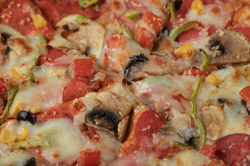 Cooked mixed ingredient pizza with pepperoni slices