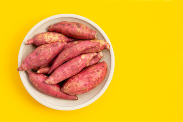 Sweet potato on yellow background.