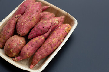 Sweet potato on dark background. Top view