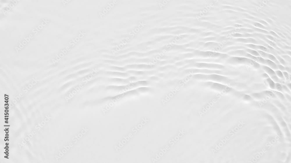 Poster up close, top view, various waves of the water surface hitting the sun's rays, making them sparkle a