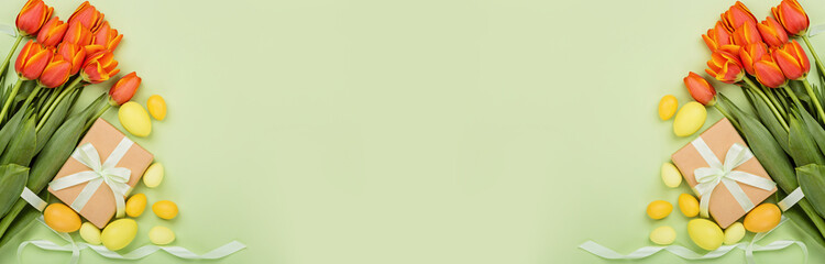 Stylish background with colorful easter eggs pastel colors isolated on green background. Horizontal...