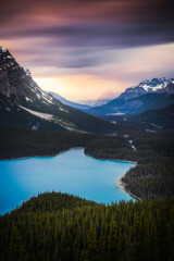 Stormy skies at sunset in a long exposure produced psychedelic colors over Peyto Lake in the Canadian Rockies.