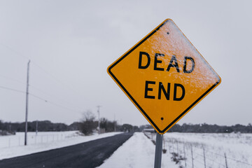 Dead end sign on snowy street