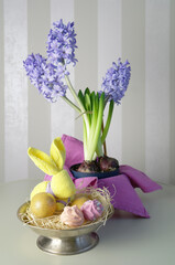 Easter bunny, lilac hyacinths and pink meringues, spring still life, selective focus
