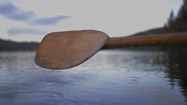 Drops Of Water Falling From The Paddle Into The River. close up