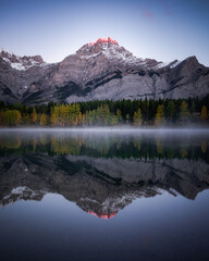 Early morning pink light hitting the summit of Mount Kidd on a cold, frosty morning in Kananaskis Country.
