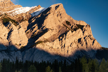 Mount Kidd warming up in the cool Autumn air at sunrise in Kananaskis Country.