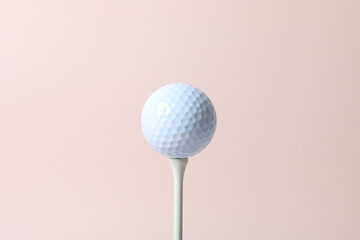 a golf ball of various colors with a pink background
