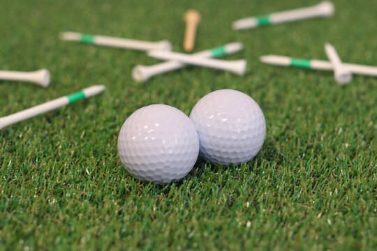 Golf Balls And Tees Lying On The Grass