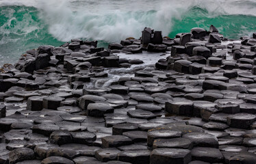 Waves crashing into basalt at the Giant's Causeway in County Antrim, Northern, Ireland - Powered by Adobe
