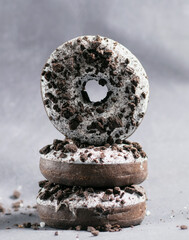 Three ring donuts with icing and chocolate pieces