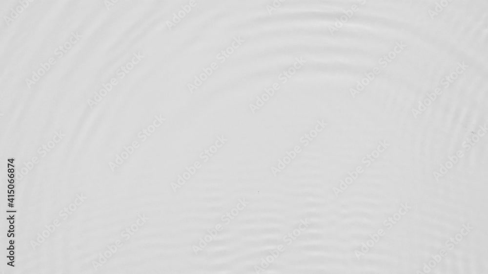 Aufkleber close up top view of water droplets falling into the water and separate splashes of water on gray ba