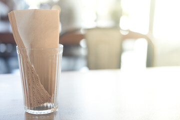 Glass with brown tissues on coffee table
