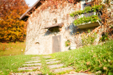 Stone path in front of blurred traditional italian house in countryside. Selective focus.