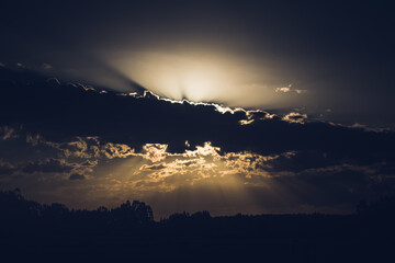 Sunset, sunlight behind the clouds