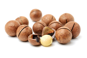 Shelled and unshelled macadamia nuts on white background 