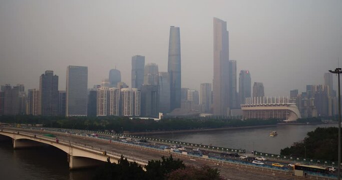 View of Guangzhou central buildings district and Guangzhou bridge over pearl river with heavy traffic in the afternoon. Aerial shot. Guangdong, China.