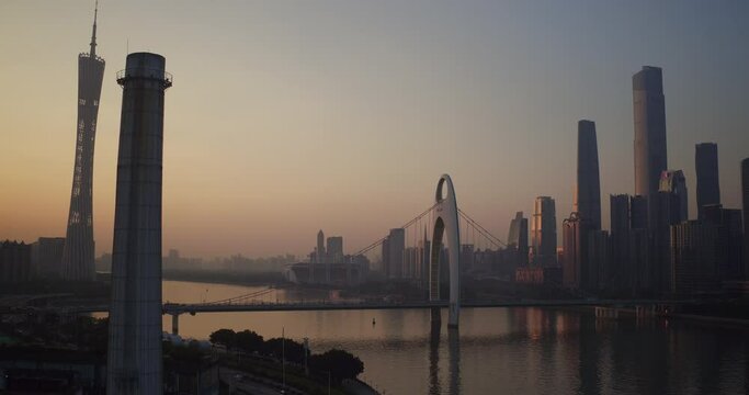 Guangzhou downtown area with Canton tower, Pearl river and central buildings district on a colorful sunset.