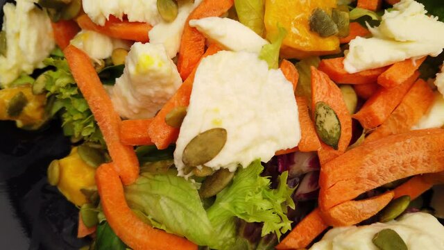 Healthy salad with mozzarella, carrots and mango - food photography