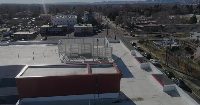 Urban apartments and rooftop featuring lightning rod. 4k drone, high bit rate.