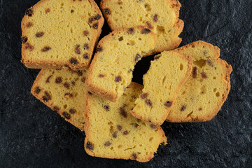 Pie slices with black sultana on a dark background