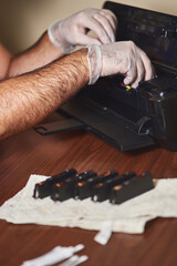 multifunctional is checked by technician. ink cartridges are out of printer. 