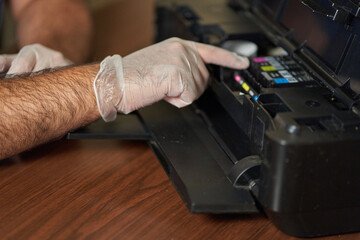 Ink catridge is removed. Printer is checked by technician.
