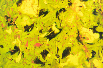 Naklejka na ściany i meble Watercolor natural background of yellow and green marble streaks with black splashes and spots close-up. Sprayed liquid textured paint for wallpaper, cards and invitations. Watercolor stains.