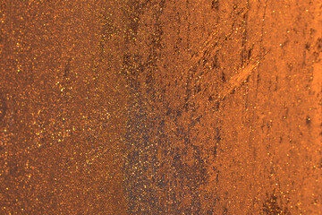 Window panes, frozen and covered with frost and ice outside, glow orange against the sunset. The shot was taken from home.