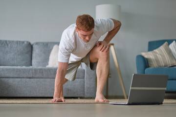 Self-care during stay at home. Fitness training, stretching exercises online men at home with...