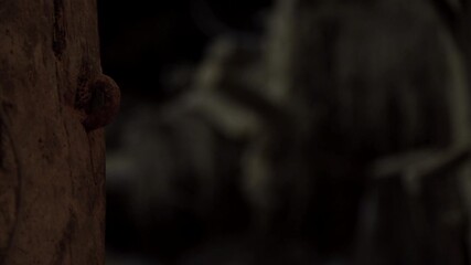 Close-up of unlocking an old rusted door bolt, opening the door and then closing and locking it again.