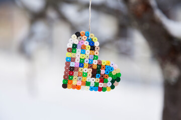 a heart of pearls hanging from a tree