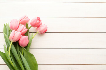 pink tulips over white wooden table background with copy space