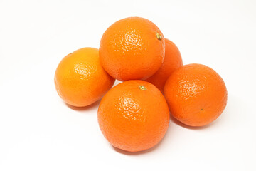 Tangerine citrus fruit group. Few ripe fresh orange tangerines on white.