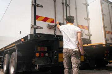 Truck driver checking container door security.	Truck inspection safety and maintenance.