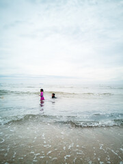 Children swimming at the beach in Malaysia.