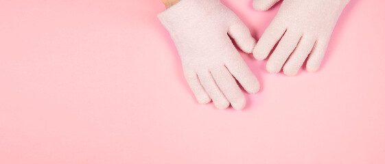 Obraz na płótnie Canvas Banner with spa gel moisturizing gloves on pink background with copy space for design. Skin care and beauty routine concept.